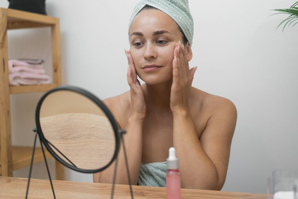 Client admiring her smooth, refreshed skin after a skincare treatment at Hideaway Wellness & Aesthetics